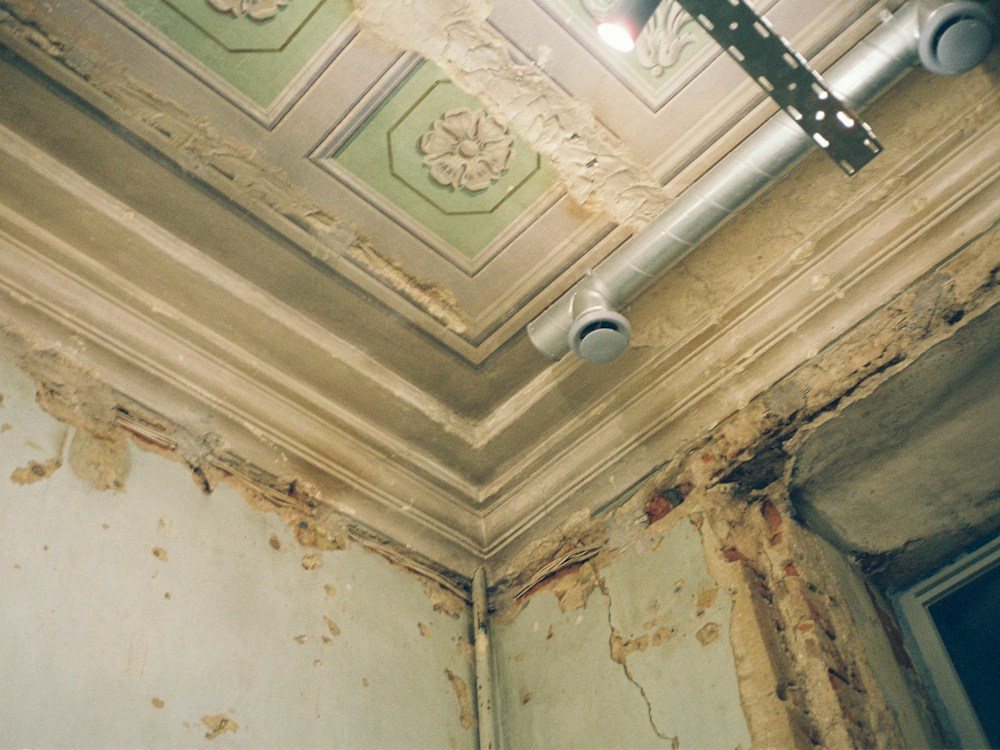 Water-stained ceiling with peeling paint